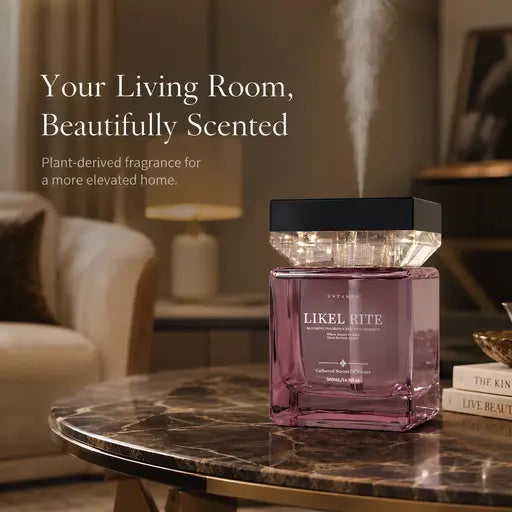 Rose-pink scent diffuser glowing on a marble coffee table in a warm living room